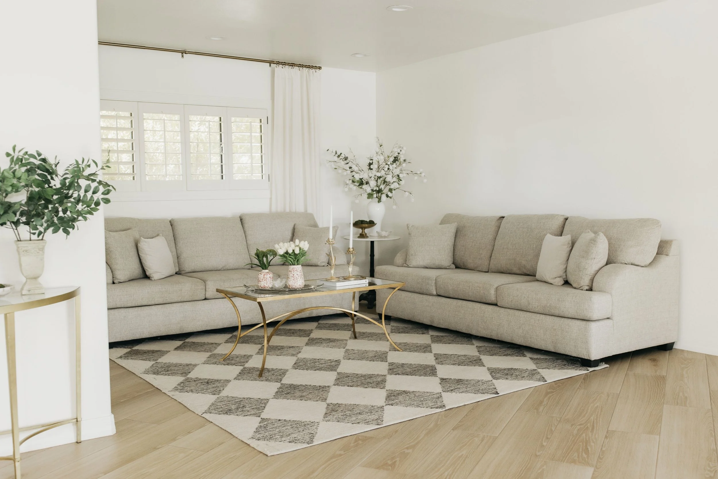 Clean, staged living room with arranged pillows and polished surfaces