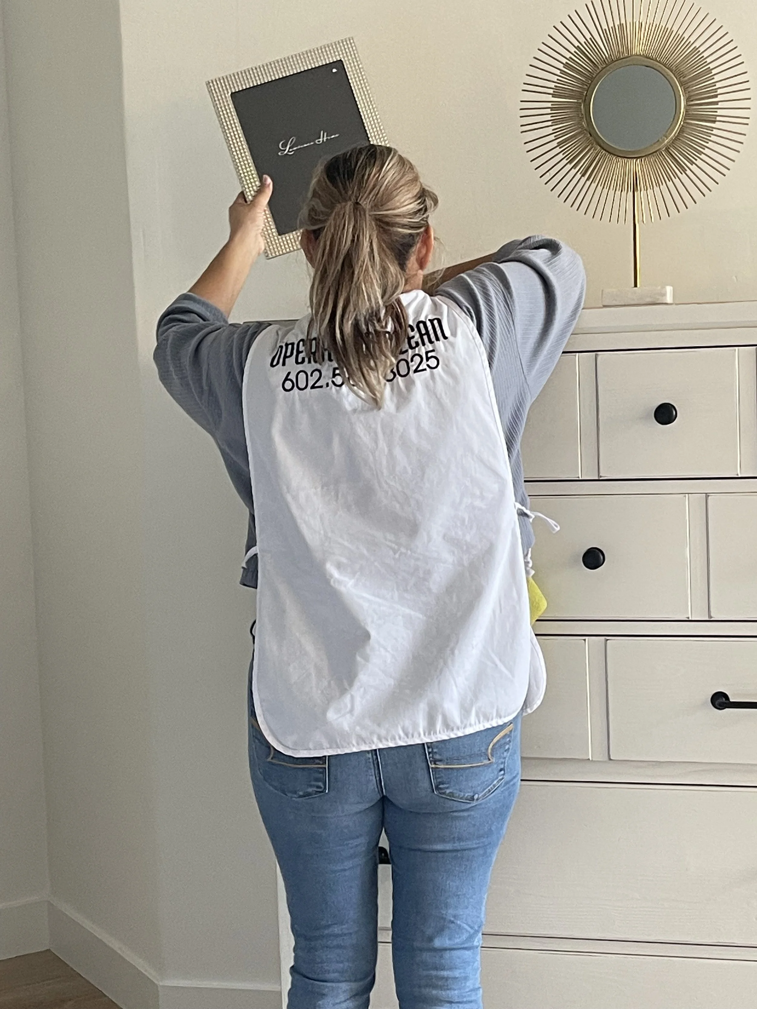 Operation Clean team member organizing bedroom décor during a detailed clean