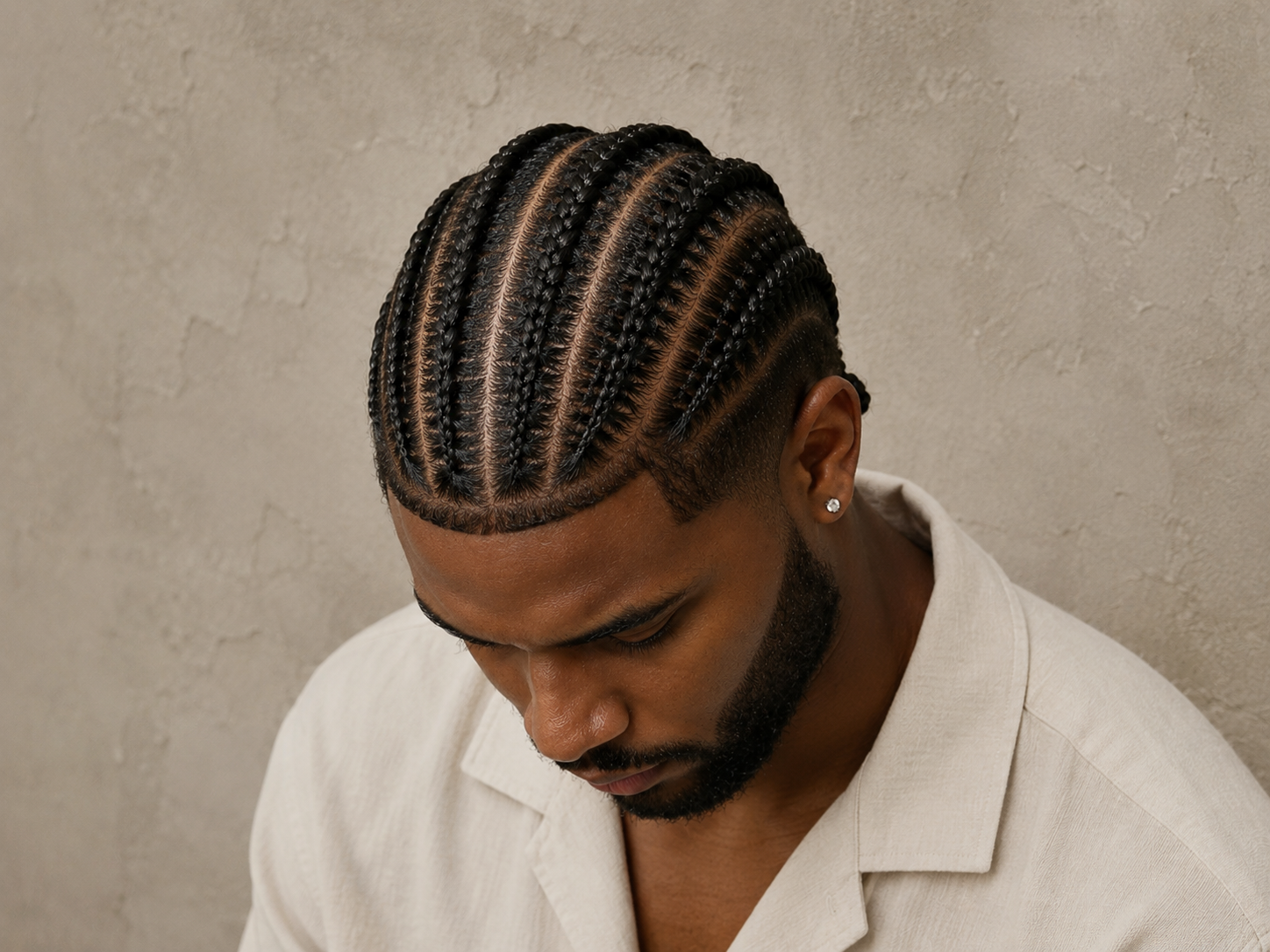 Men's braided hairstyle at Iconique Hair Salon, Whitby, Ontario. Expert cornrows and braids for men serving Durham Region. Walk-ins welcome alongside bookings. Opening October 2026.