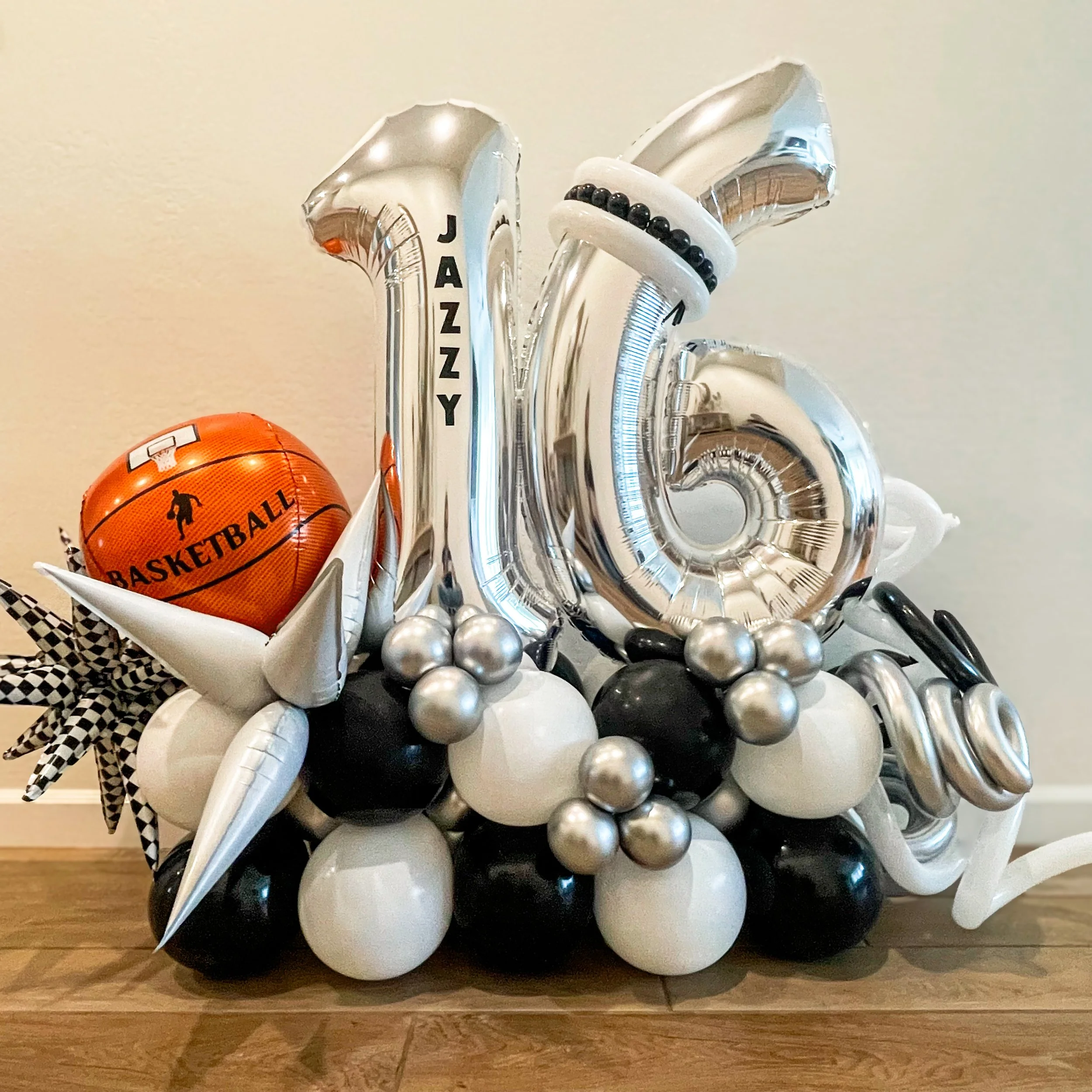 Arrangement of basketball-themed balloons and silver, black, and white balloons stack.  Birthday balloons . Grab & Go