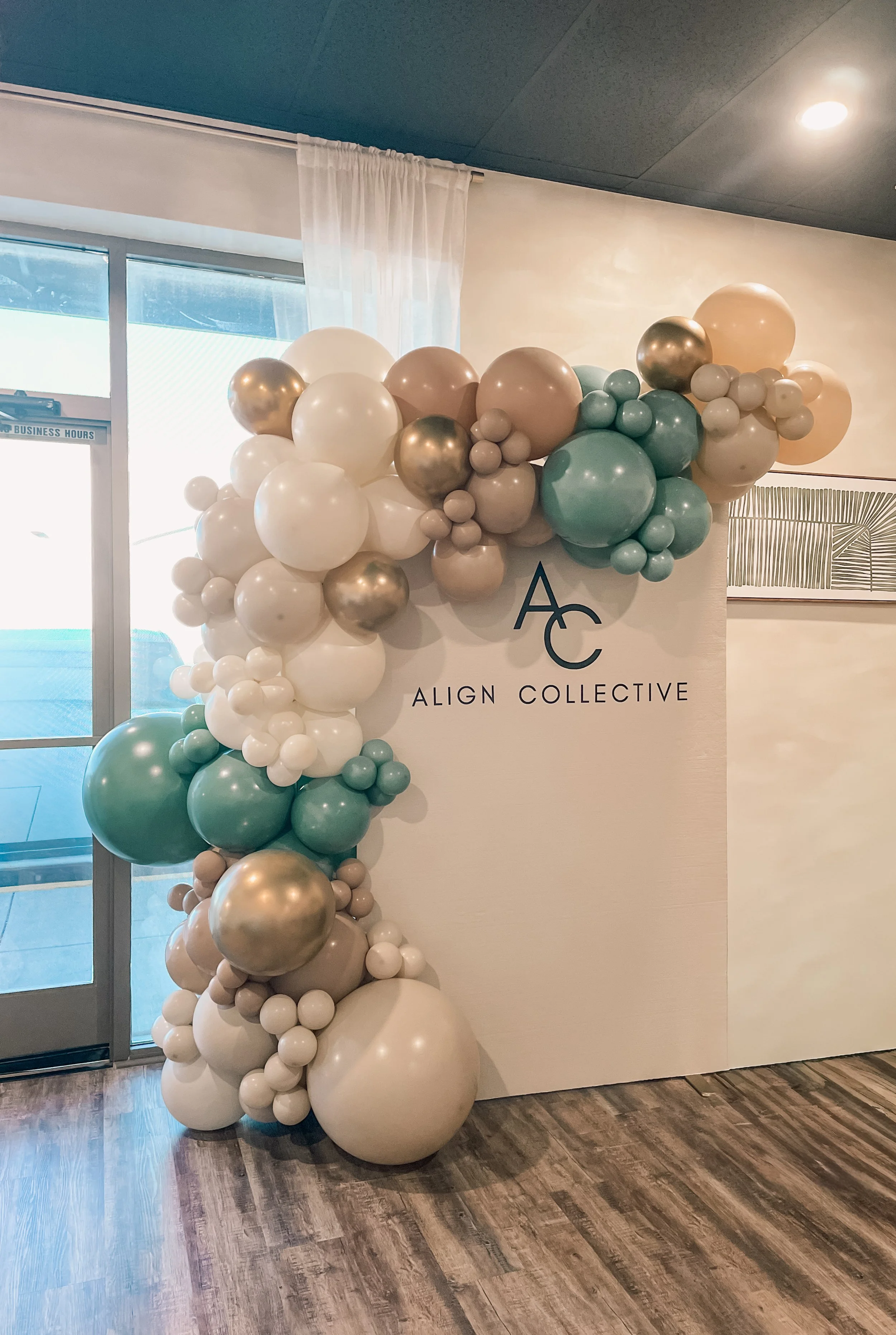 Sage, Cream, Gold Organic Balloon Arch on cream backdrop - grand opening