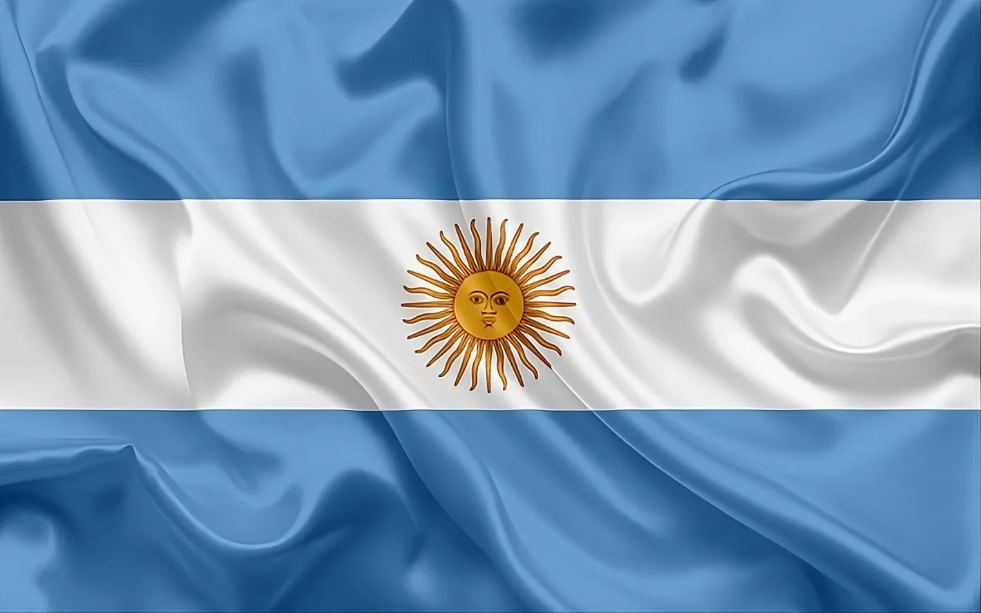 The flag of Argentina with light blue and white horizontal stripes and a golden sun with a face in the center.