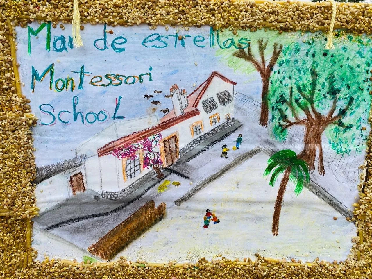 A child's drawing of a school named 'Man de estrellas Montessori school', with a building, trees, and children playing outside, surrounded by a border of seeds.