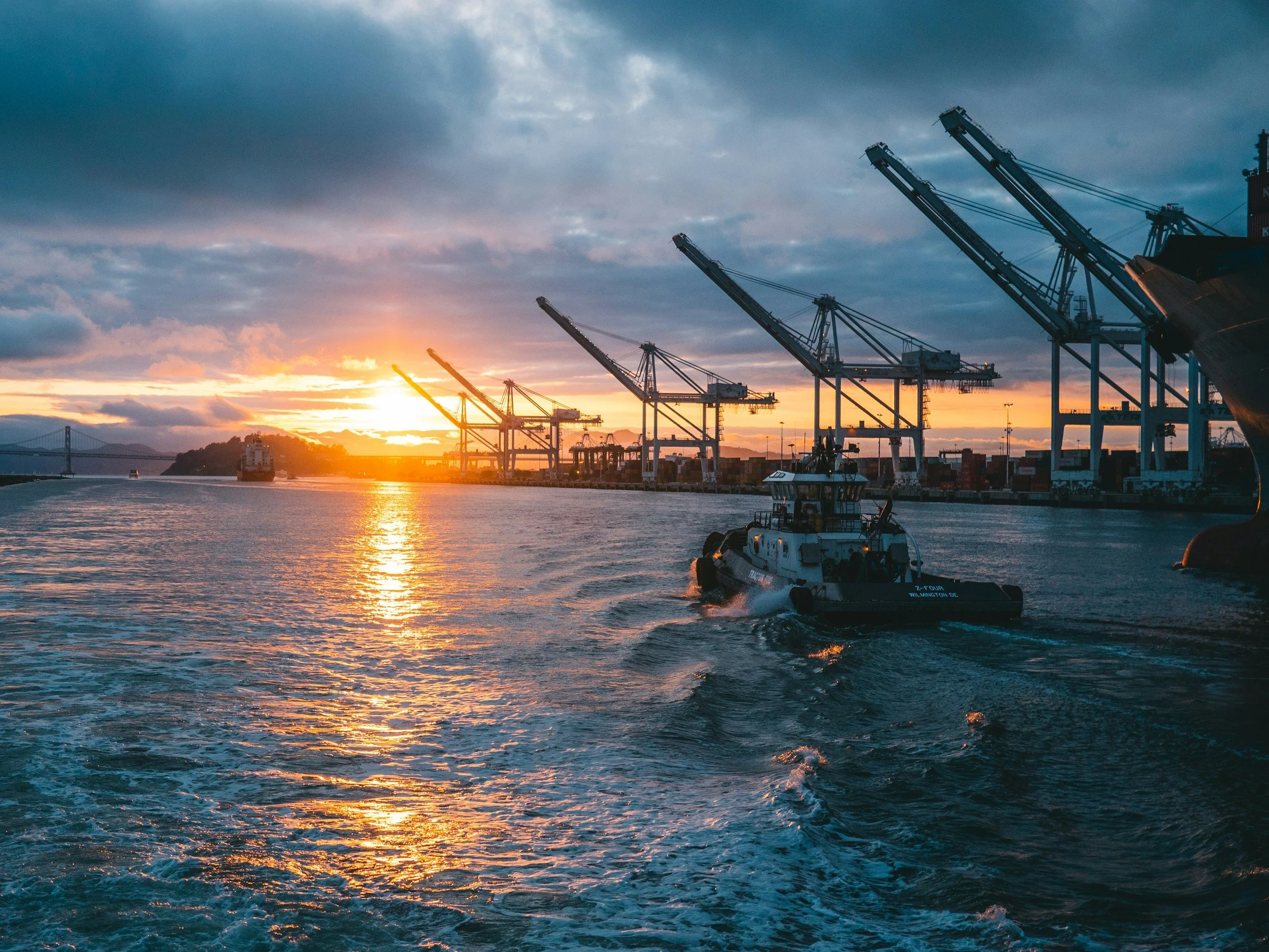 Port infrastructure at sunset representing logistics, maritime operations and supply chain advisory services.