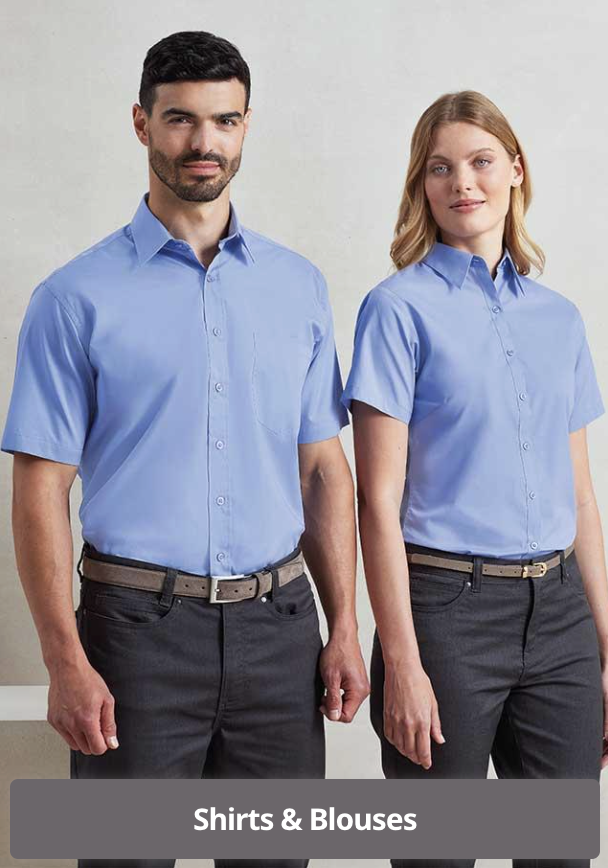 A man and a woman standing side by side against a plain background, both wearing light blue button-up shirts and dark pants.