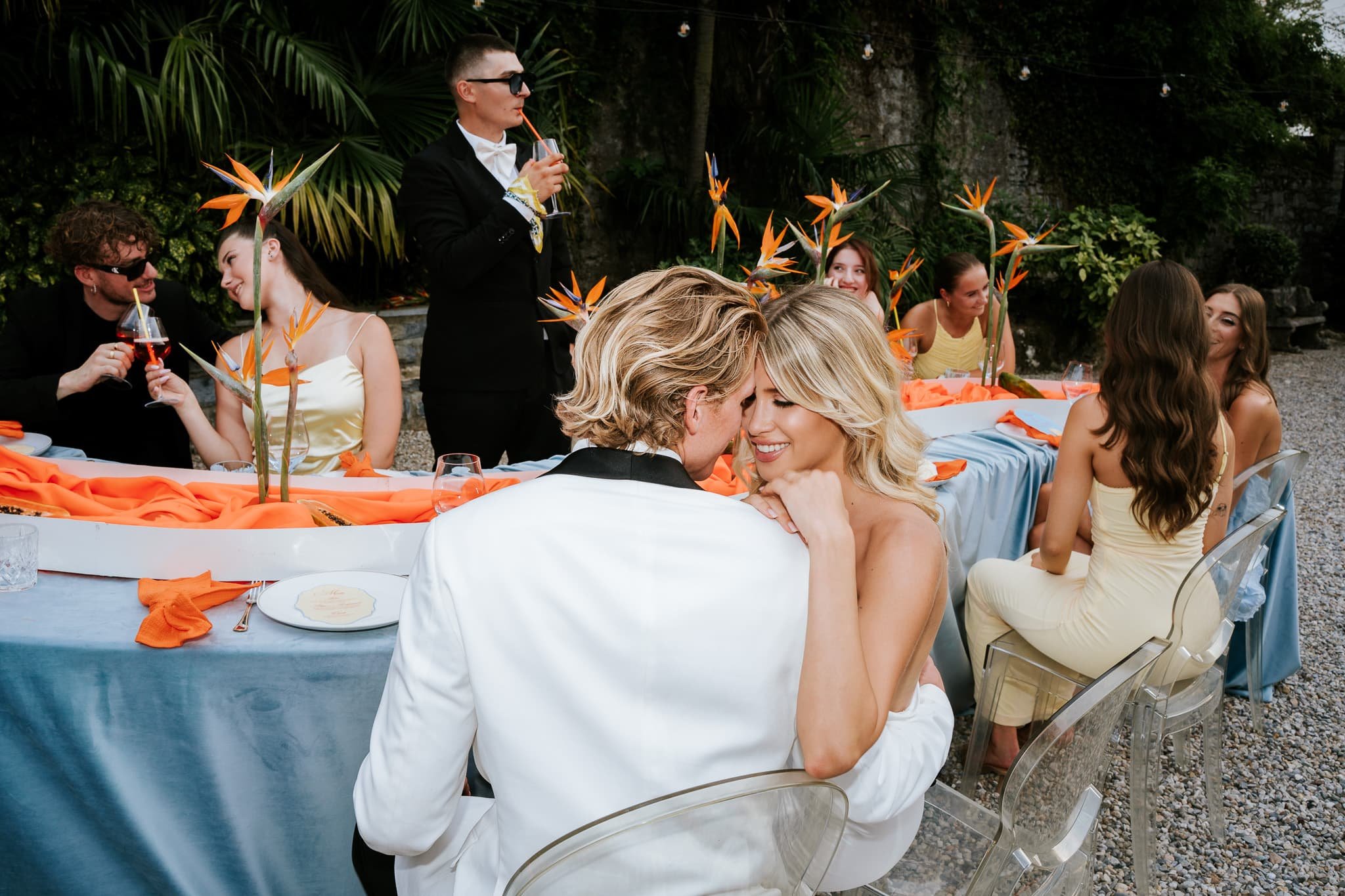 Bride and groom celebrating with a champagne tower outdoors during a stylish Lake Como wedding reception.