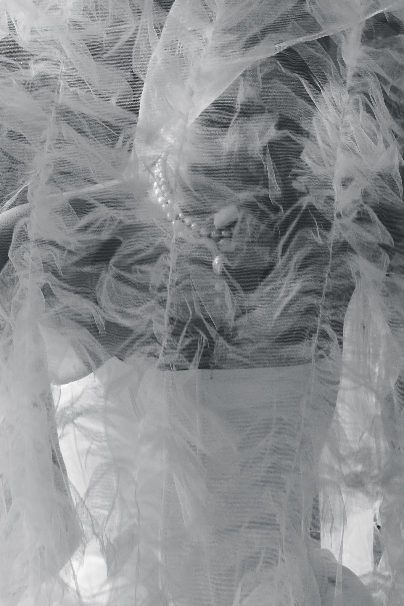 Close-up detail of a bride's veil catching the light and wind during a boat ride on Lake Como.