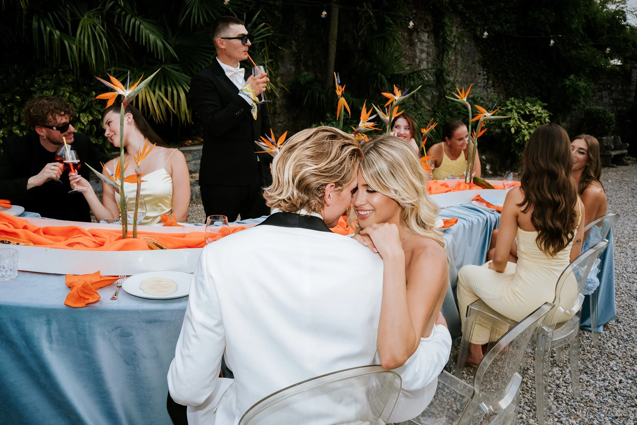 Bride and groom celebrating with a champagne tower outdoors during a stylish Lake Como wedding reception.
