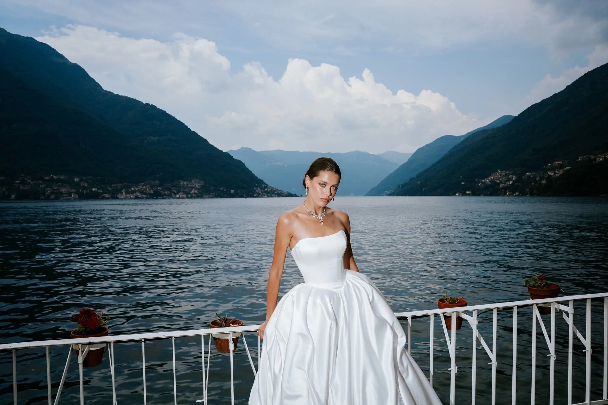editorial portrait of a bride at her lake como villa lake side view 