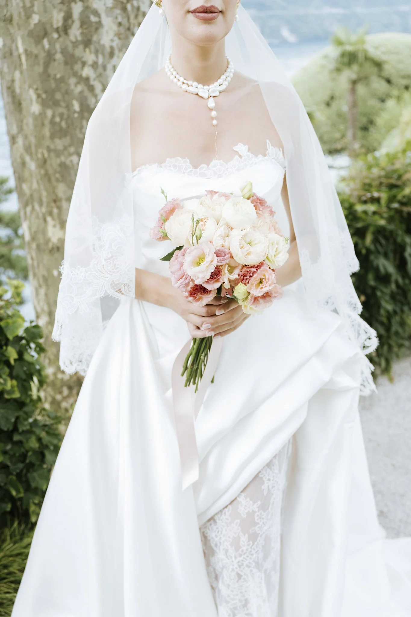 Close-up of a bride's bouquet of pink and white flowers at Villa del Balbianello, Lake Como.
