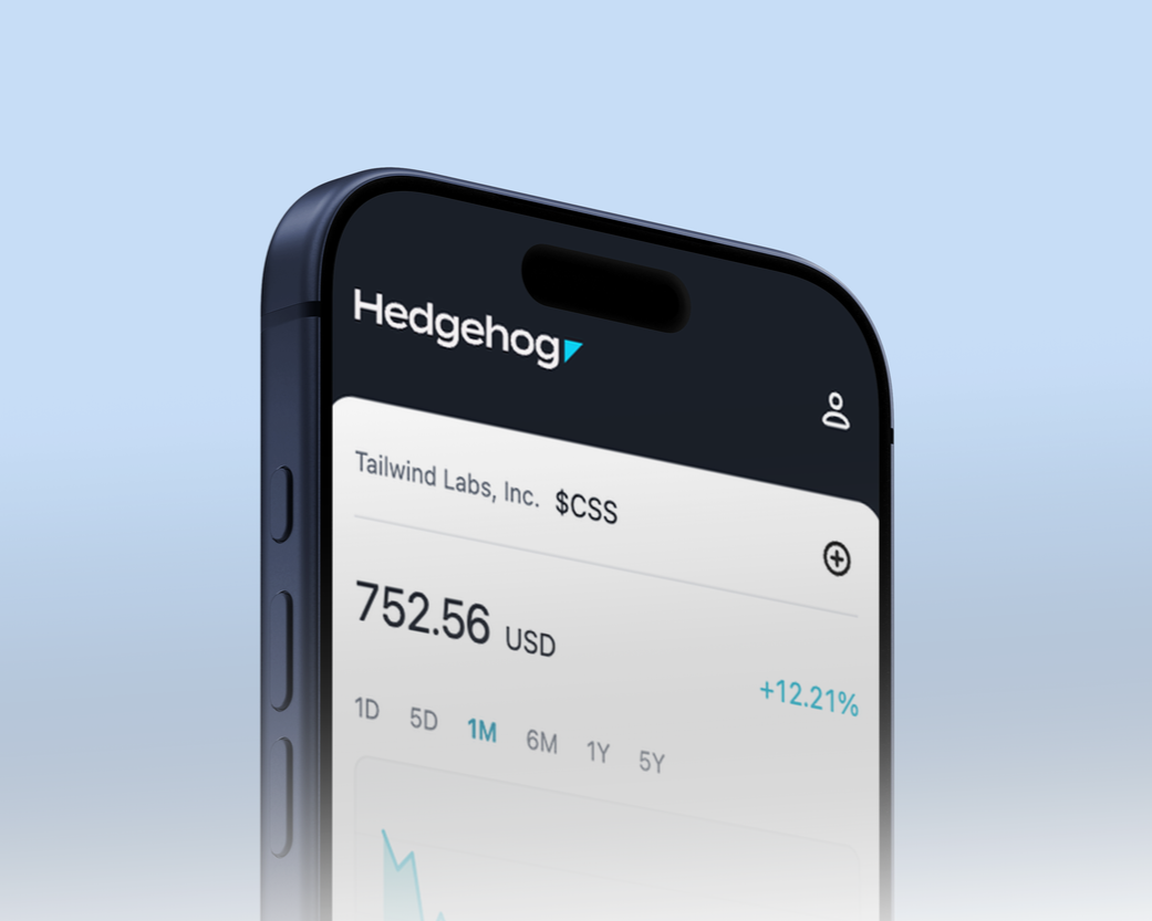 Close-up of a smartphone screen displaying a financial app with stock information for Tailwind Labs, Inc., showing a stock price of 752.56 USD and a 12.21% increase, with a light blue background.