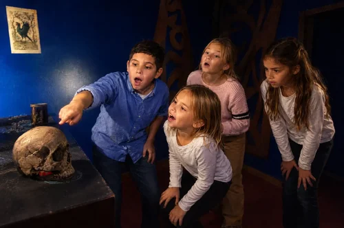 School group solving clues in the Young Wednesday escape room at Escape London