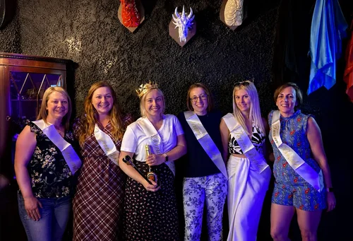 Hen party in Team Bride sashes celebrating after an escape room at Escape London
