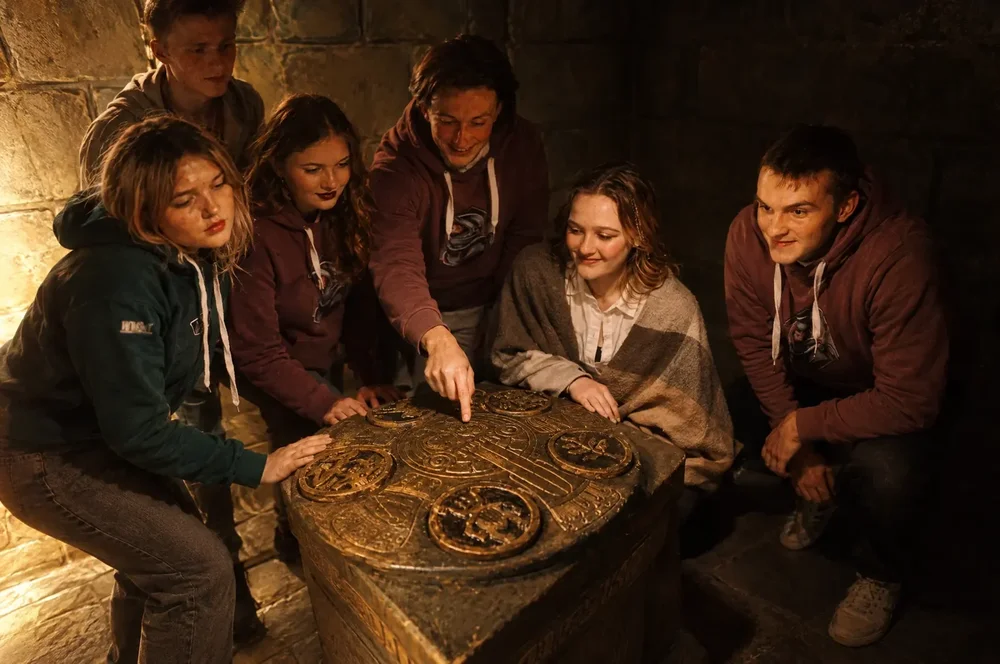 Experienced team working through a puzzle in the Mayan Temple escape room at Escape London