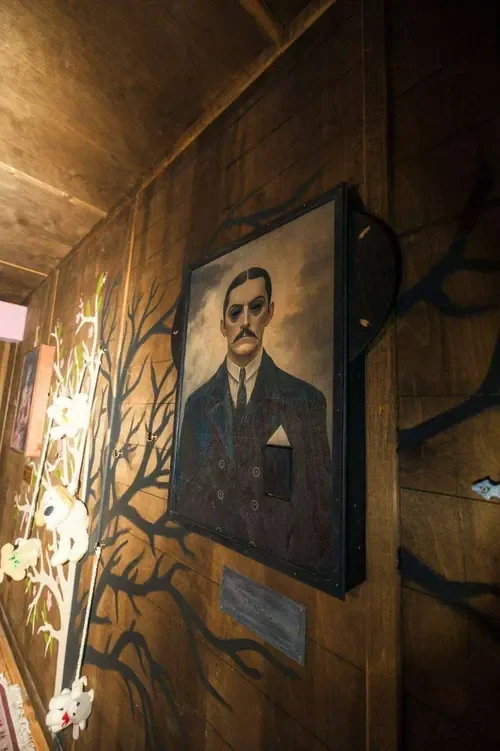 A brooding family portrait on the panelled wall in Young Wednesday — Escape London Hammersmith