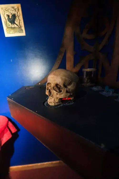 A skull resting on the dark altar table in Young Wednesday — Escape London Hammersmith