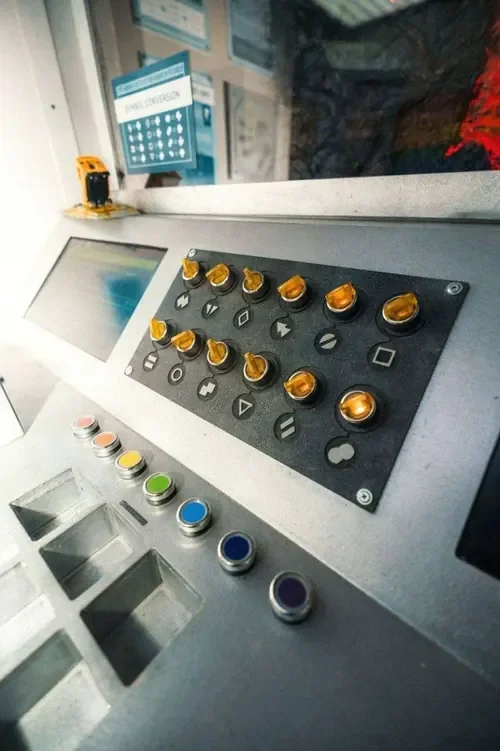 A control panel of glowing buttons and switches in Things Are Strange — Escape London Hammersmith