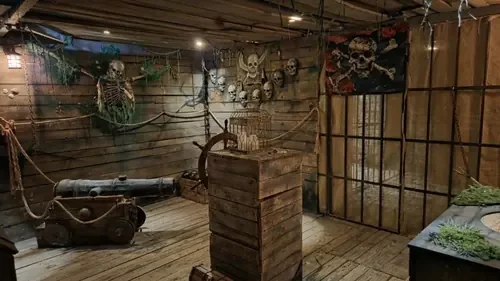 The pirate deck of The Flying Dutchman with cannon and skull wall — Escape London Islington