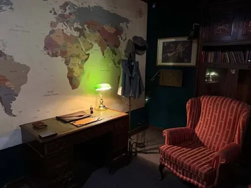 The detective’s study with world map and green banker’s lamp — 221B Baker Street, Escape London Islington