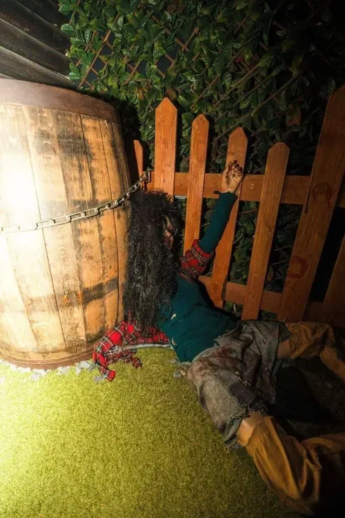 A victim chained beside the barrel in The Master’s Cabin — Escape London Shepherd’s Bush