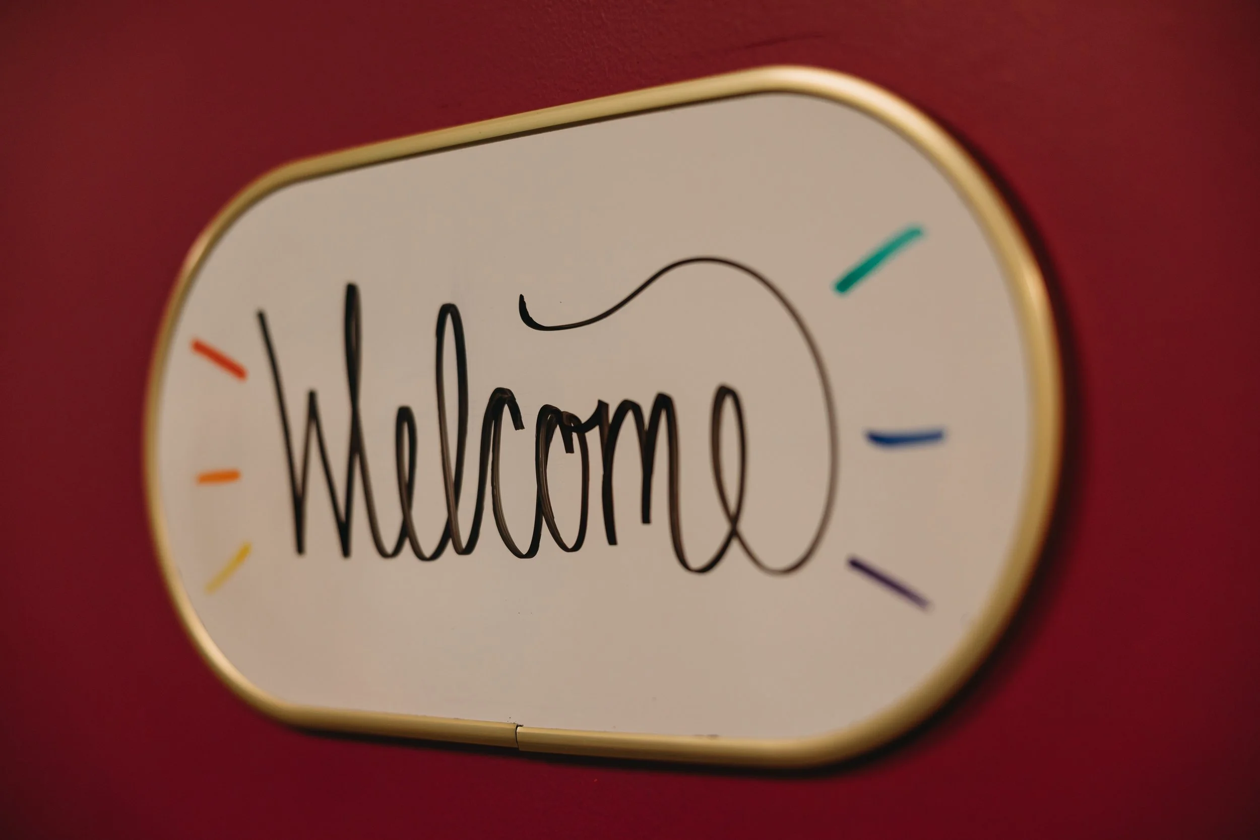 Colorful welcome sign inside a pediatric neuropsychology private practice, creating a warm, child-friendly environment for child development psychology services.