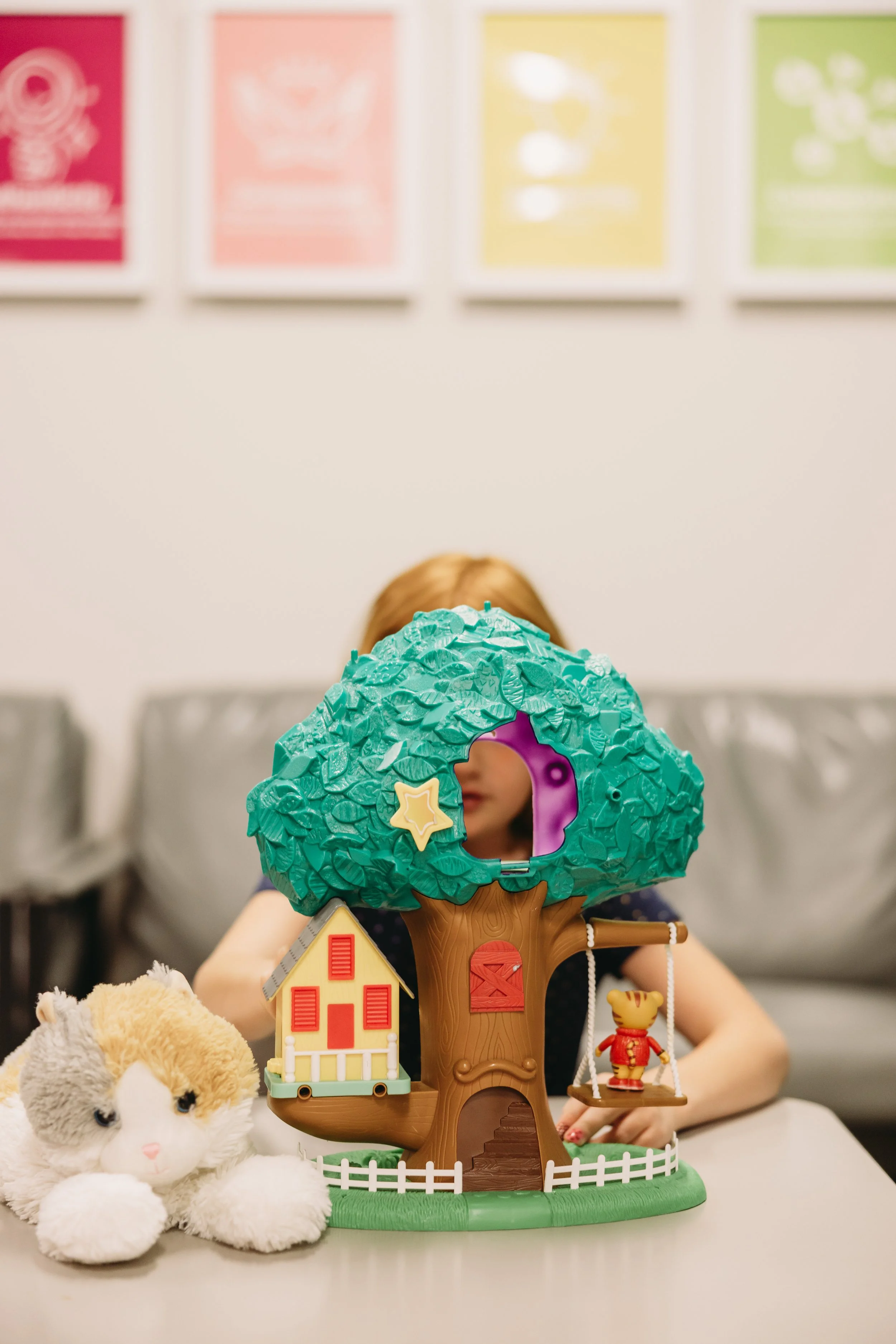 Child playing with a treehouse toy in a welcoming clinic offering neuropsychological testing and neurological evaluations in MN and learning disability testing.