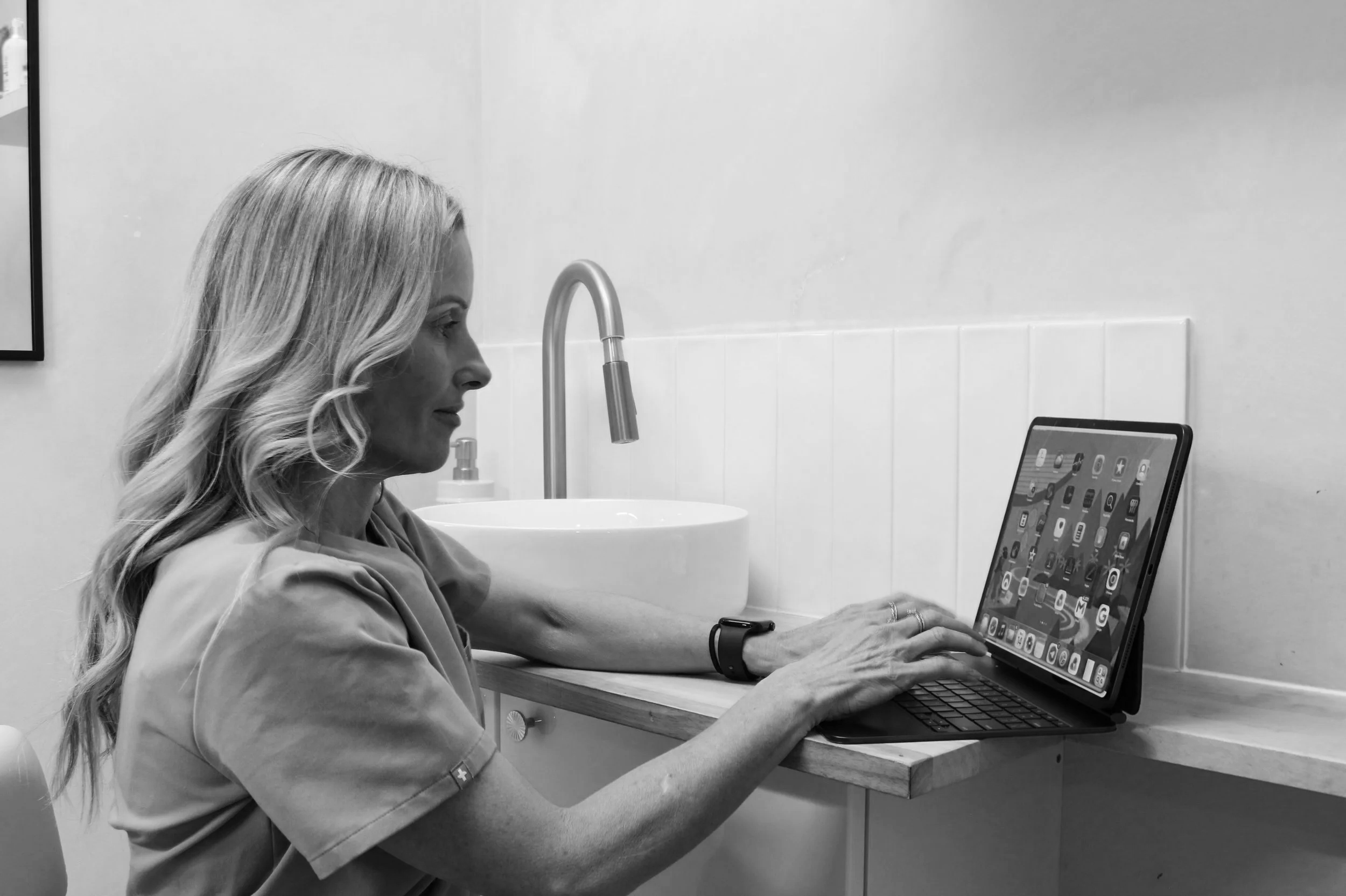 Ren Aesthetics practitioner working on a laptop