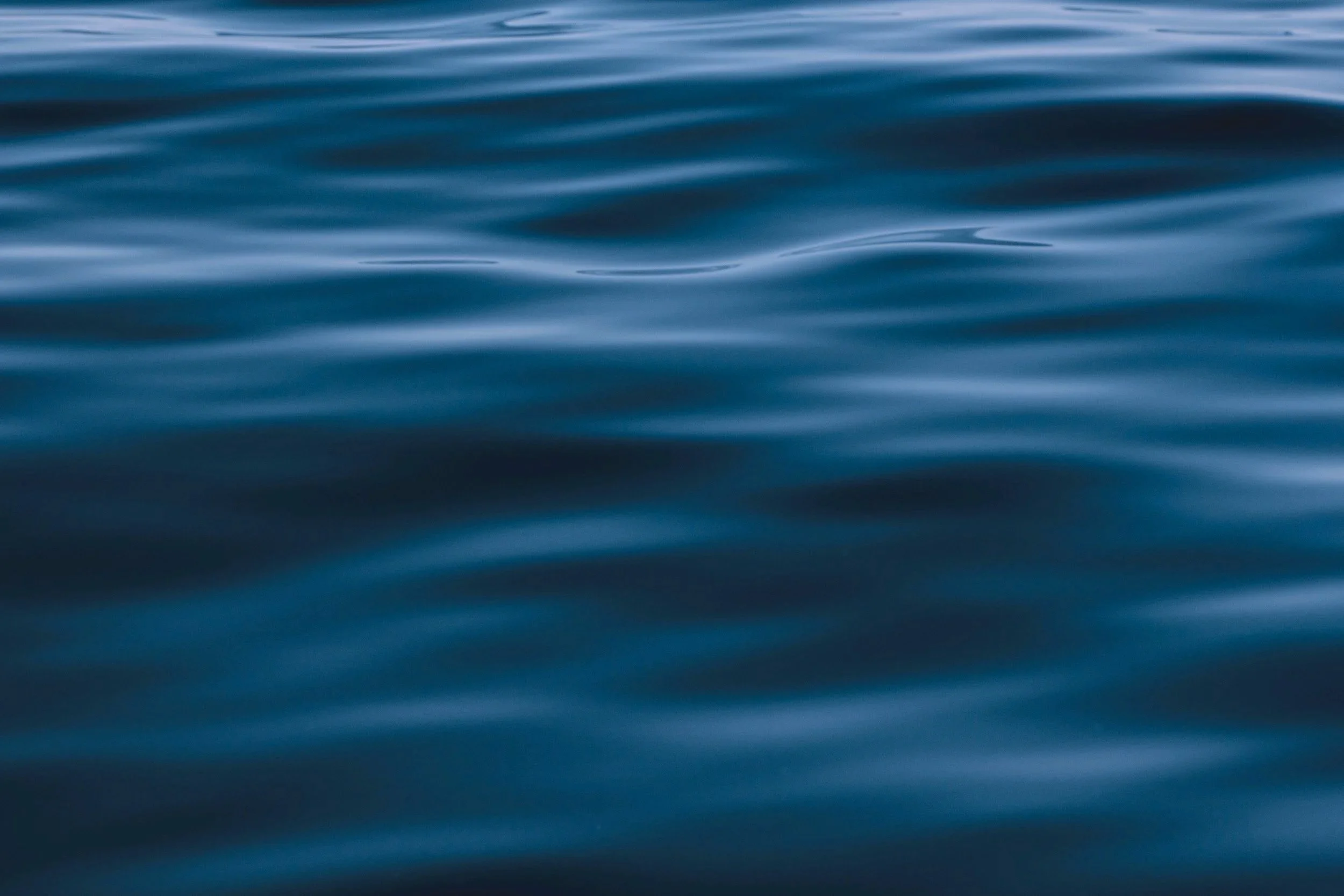 Calm ocean water with small gentle waves.
