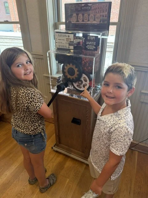 Gavin and Briella using the Forever Penny machine at Lititz Springs Park