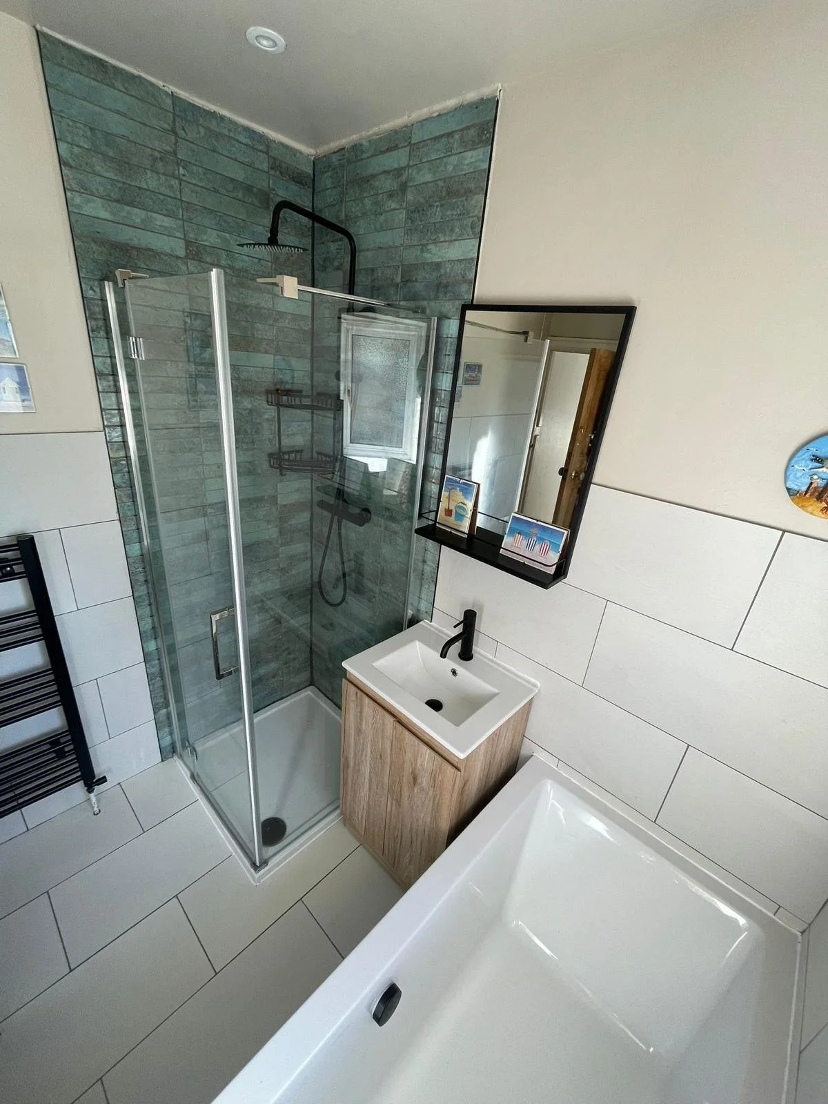 Full bathroom with natural stone floor and wall tiles and statement subway tiled shower.