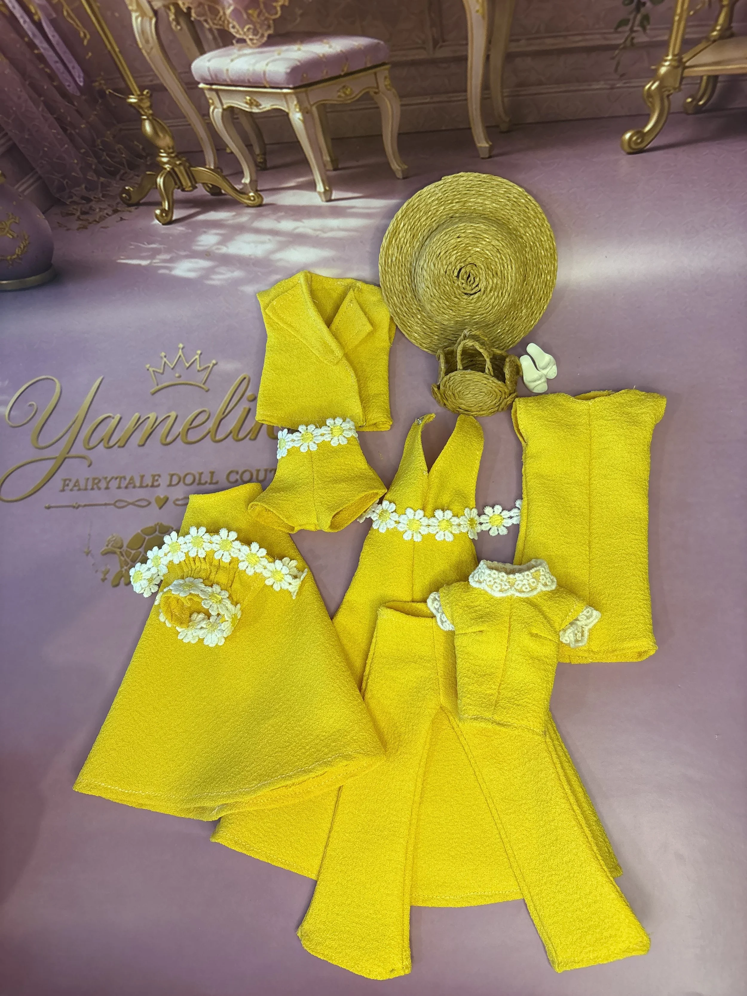 Fashion dolls styled in handmade yellow outfits from Yamelika’s Lemon Drop collection, featuring dresses, trousers, shorts and handcrafted doll accessories.