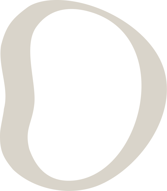 Close-up of a black and white cookie with smooth, shiny surface and a slightly cracked edge.
