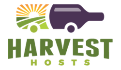 A logo with a purple tractor, a bright yellow sun, green fields, and the words 'HARVEST HOSTS' in bold green letters.