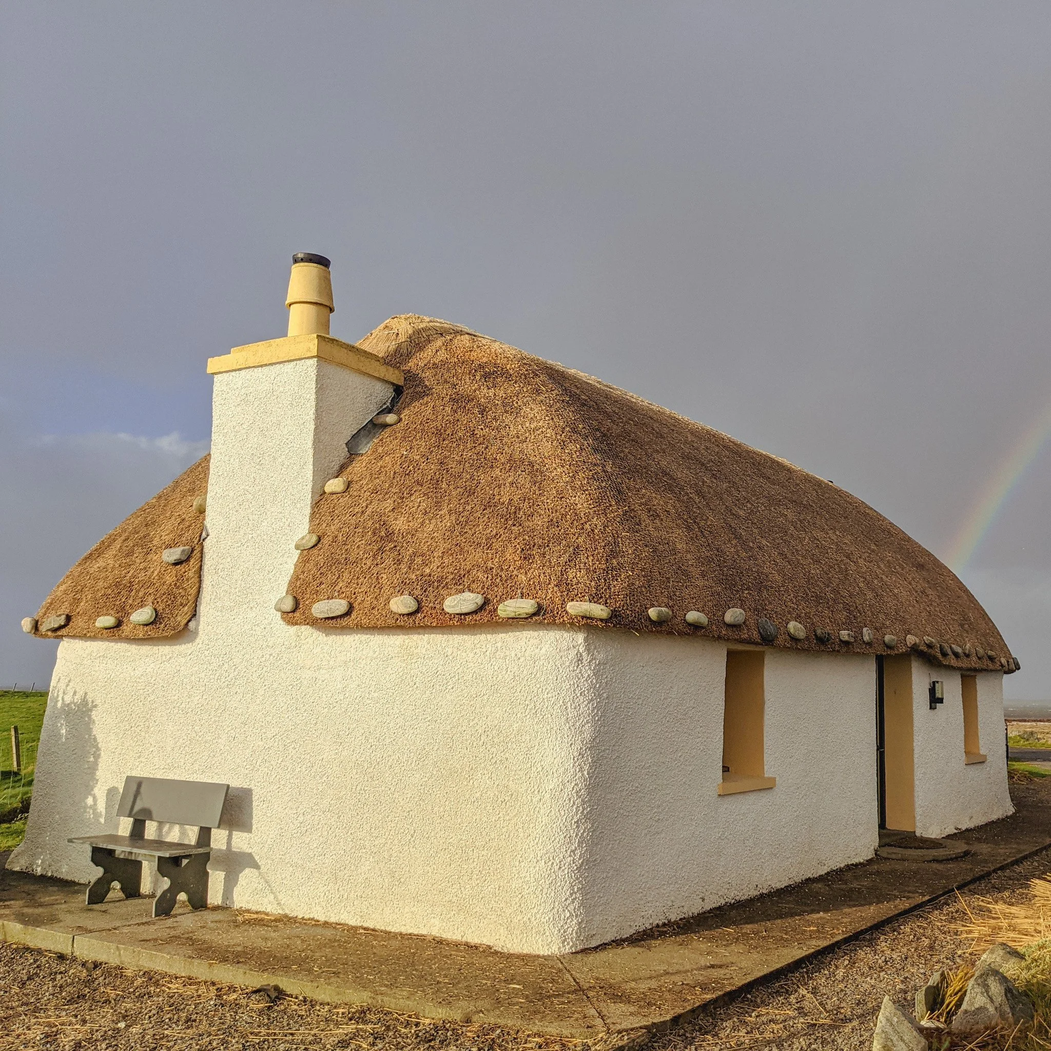 A blackhouse on South Uist, Western Isles, Scottish water reed with traditional weighting stones.