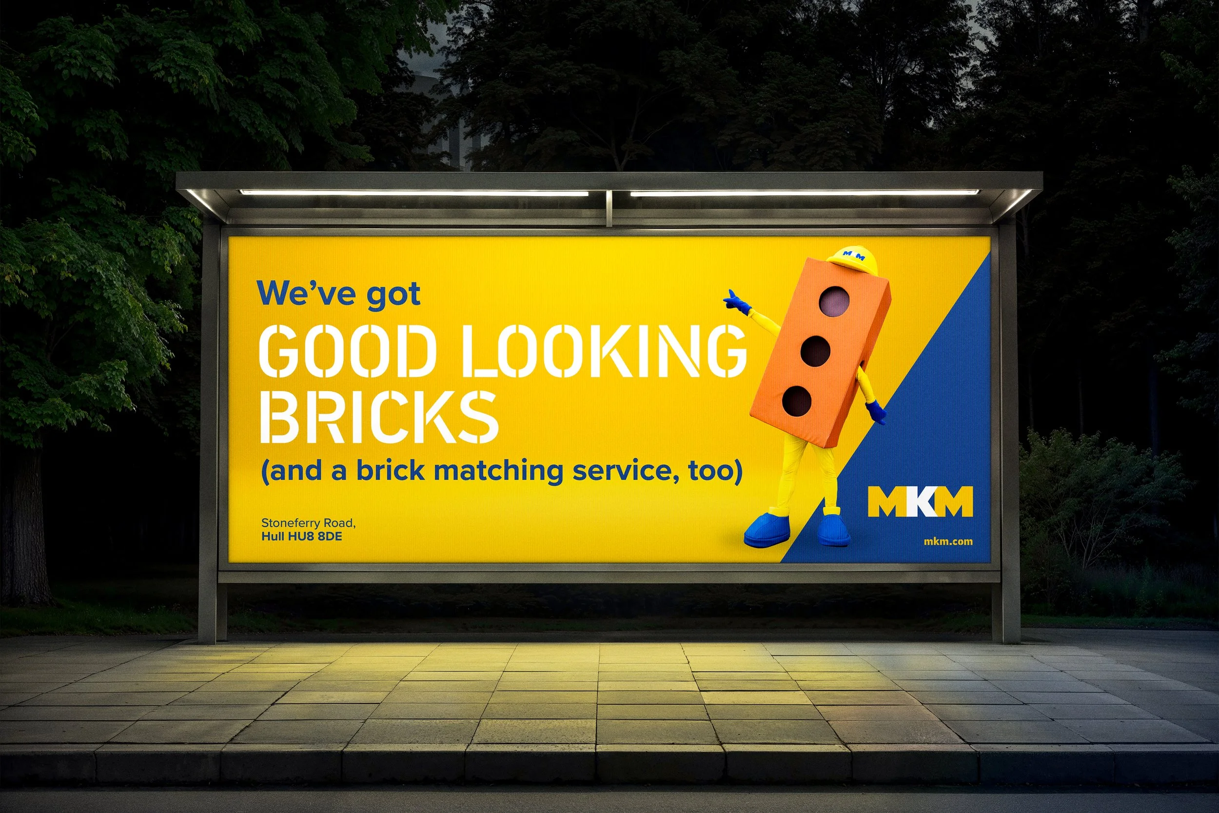 MKM brick matching advert featuring Bricky the mascot on a bus stop billboard
