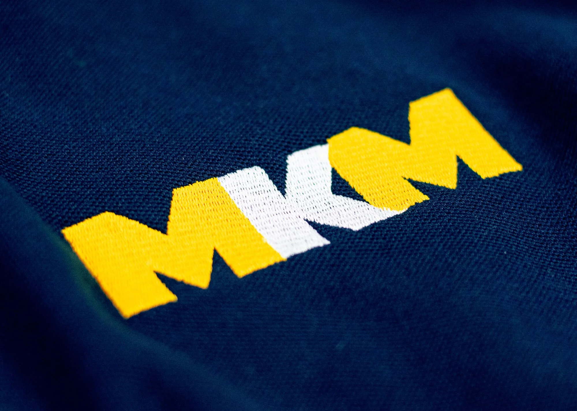 MKM logo embroidered on branded workwear following the rebrand