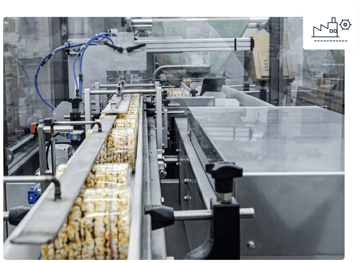 Factory production line with a conveyor belt filled with packaged popcorn in an automated food packaging machine.