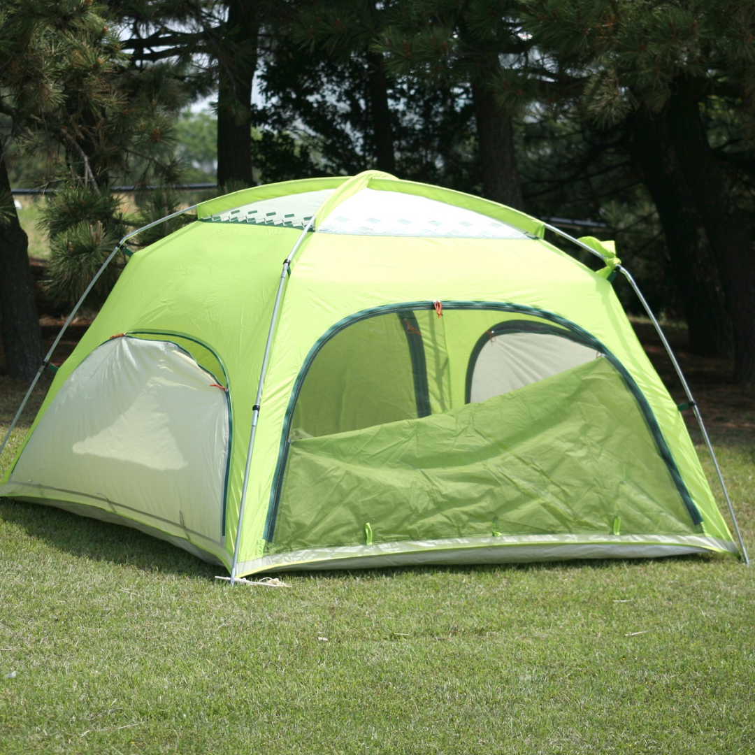 A green tent on grass