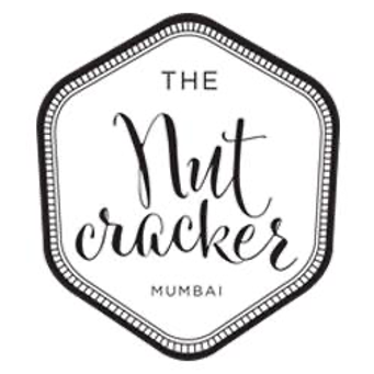 Logo for The Nut Cracker Mumbai with a hexagonal shape and decorative border.