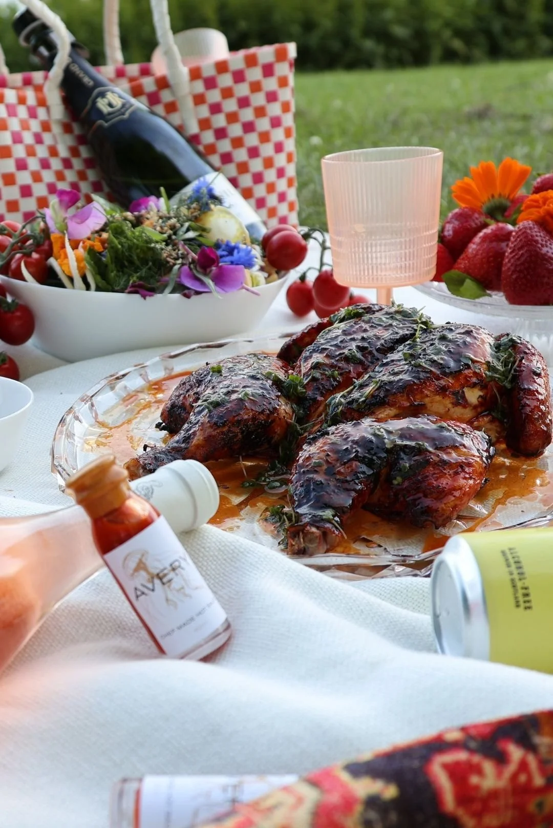 Gourmet picnic to order shown on a white tablecloth with all the sides including Avery hot sauce — Kilted Chicken by Chef Rodney Wages