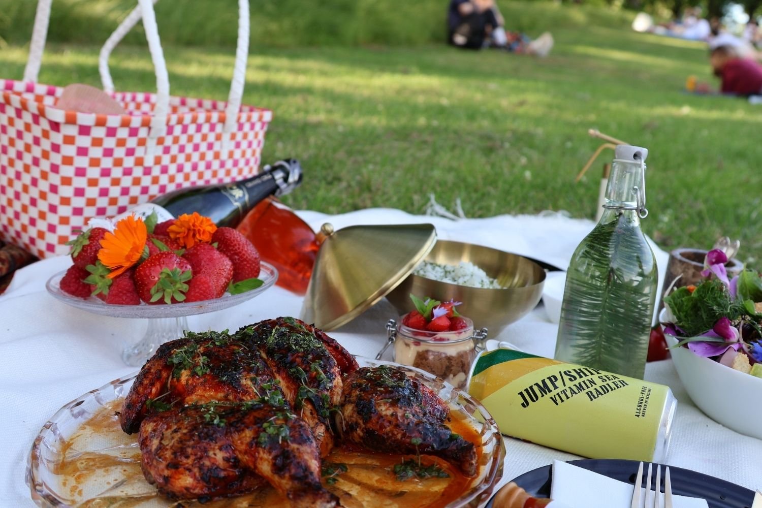 Heritage breed chicken takeaway in Edinburgh with picnic basket, drinks, on grass with blanket — Kilted Chicken by Chef Rodney Wages