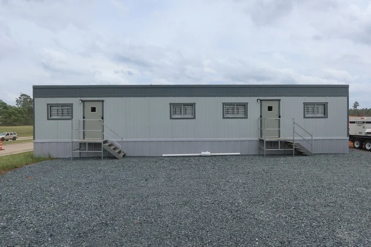 12x56 single-wide office trailer on a Central Texas job site