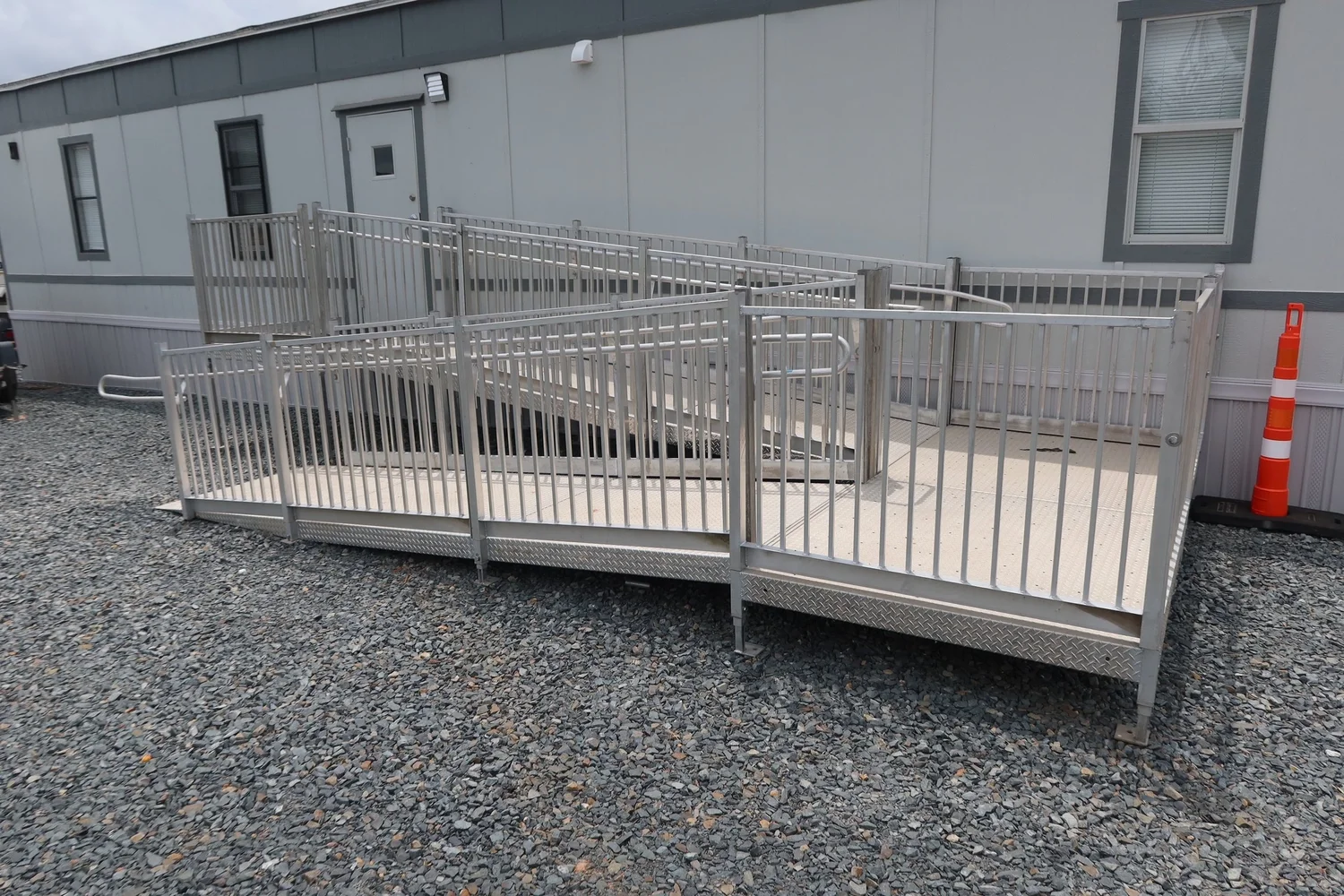 ADA-compliant aluminum entry ramp on a modular office trailer