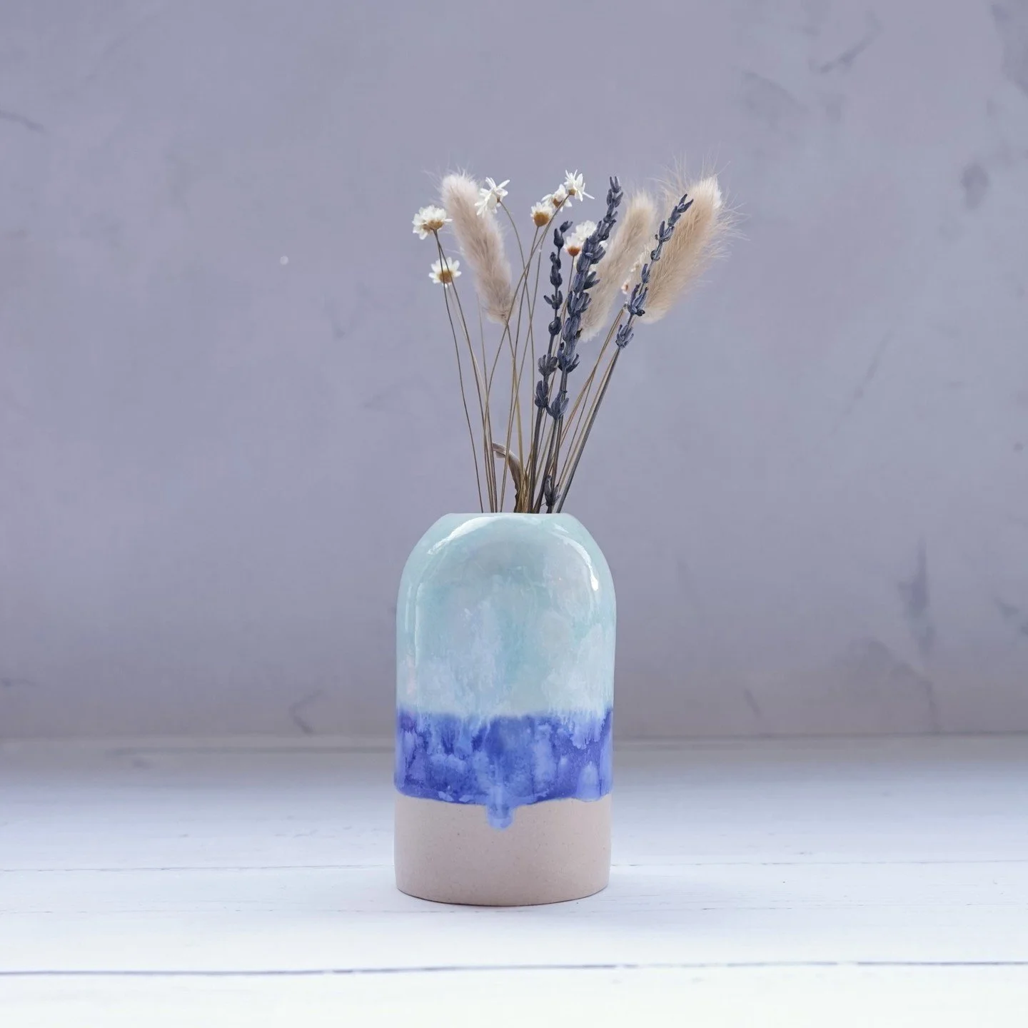 Light turquoise vase with crystal blooms on the surface, running into a darker, cobalt blue band
.
.
.
.
.
#ceramicvase
#handmadegift
#smallvase
#makersgonnamake