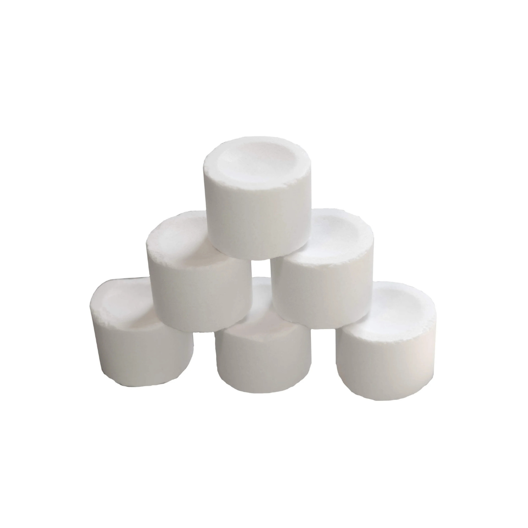 Six white pond bacteria pellets stacked in a pyramid on a plain white background.