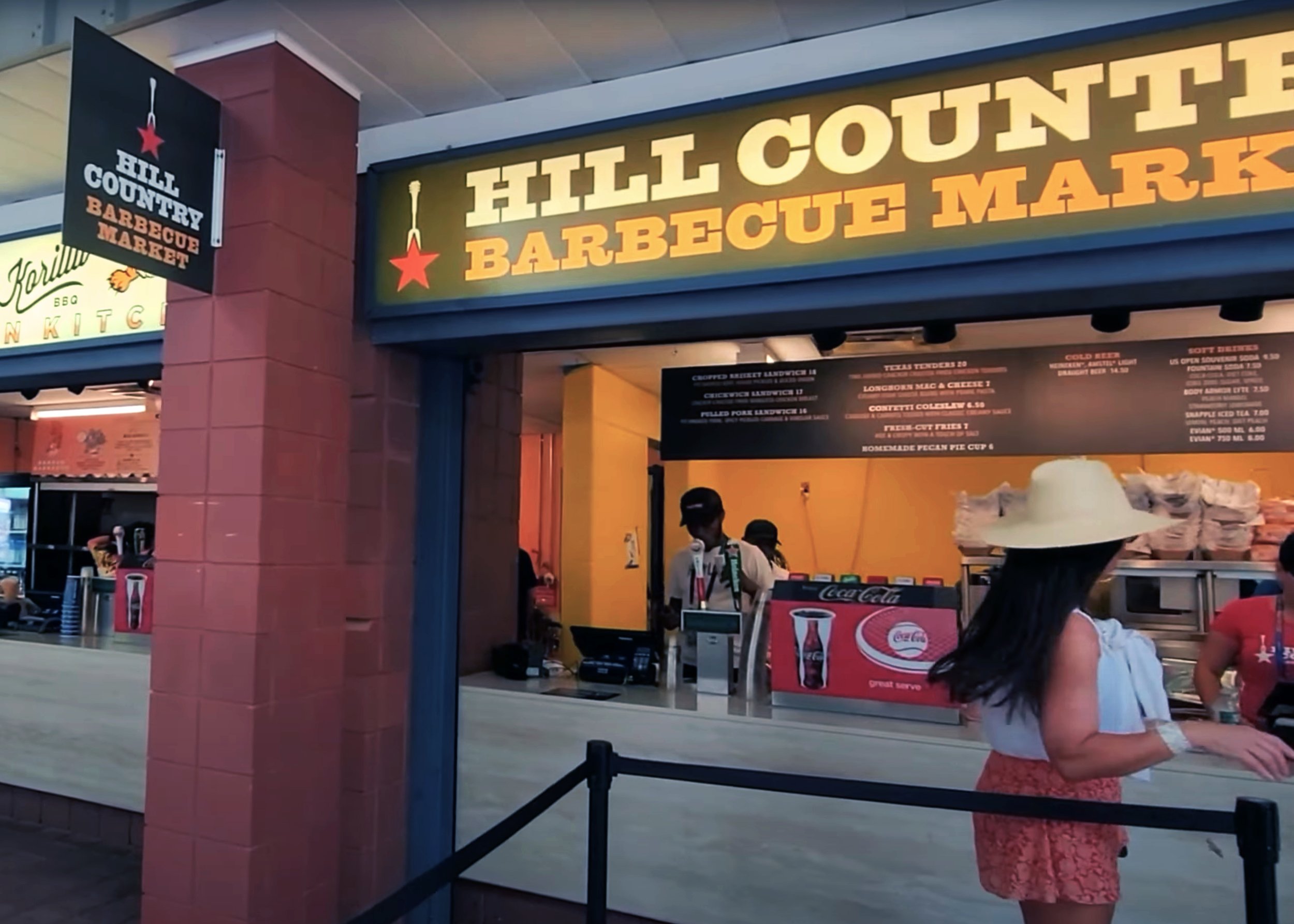 Hill Country US Open concession with a projecting logo sign, overhead fascia and menu board.