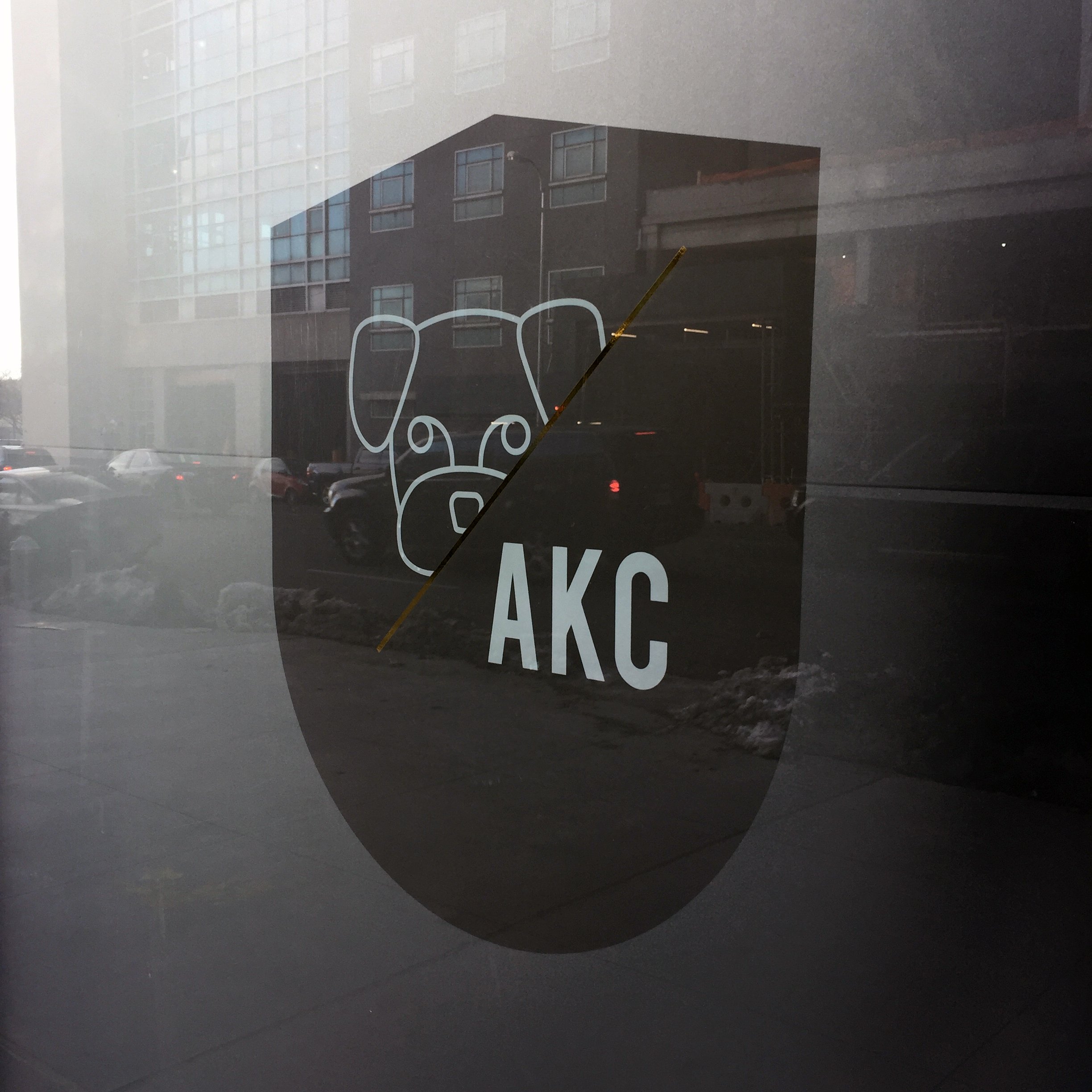 AKC Canine Retreat logo applied to frosted glass signage