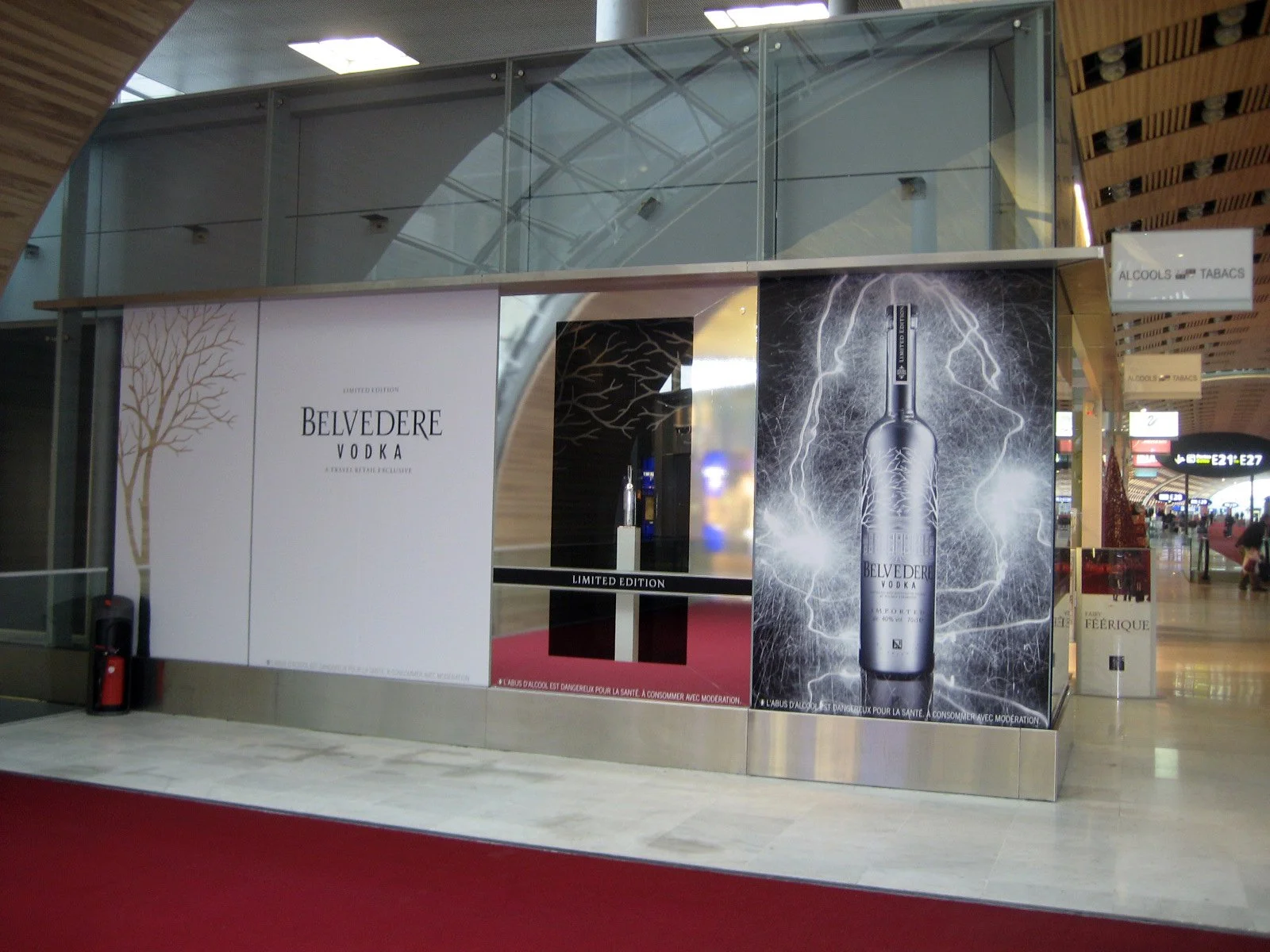 Belvedere airport display with a white wordmark panel, mirrored bottle niche and illuminated bottle artwork.