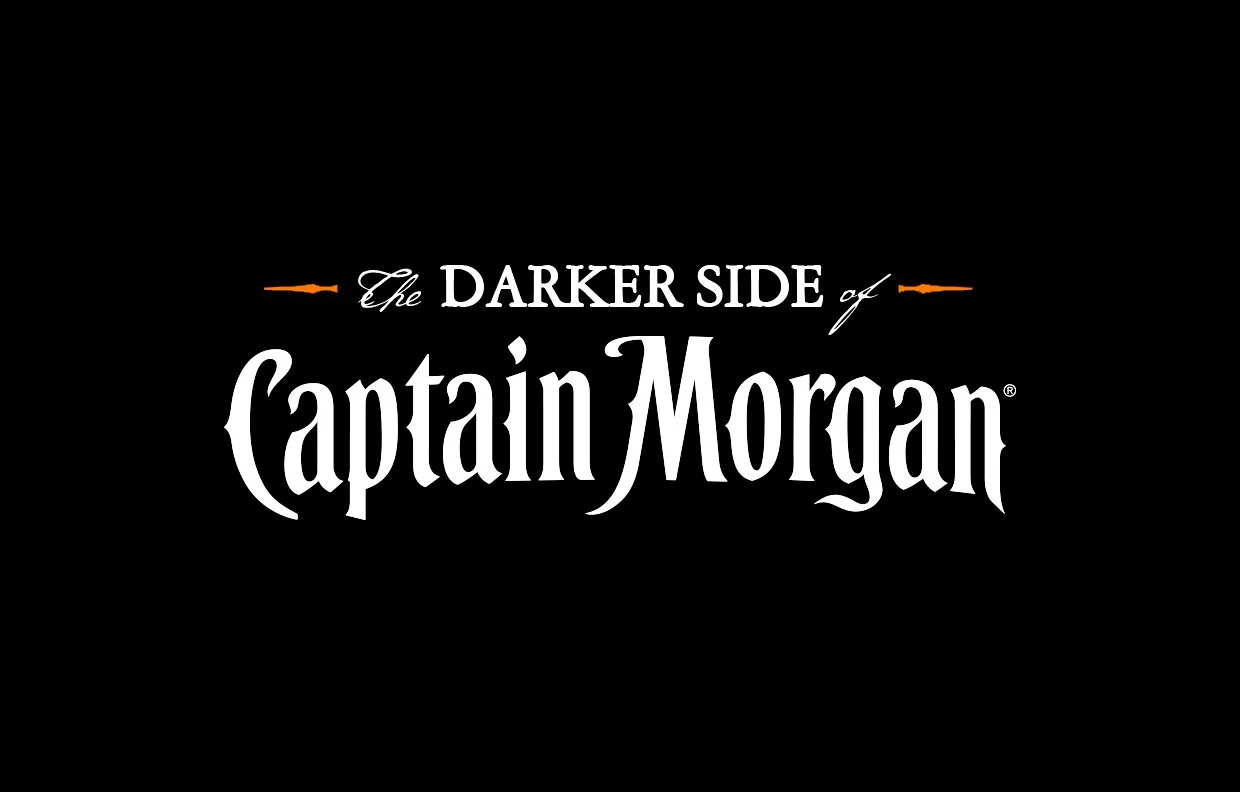 The Darker Side of Captain Morgan campaign wordmark in white and copper on black.