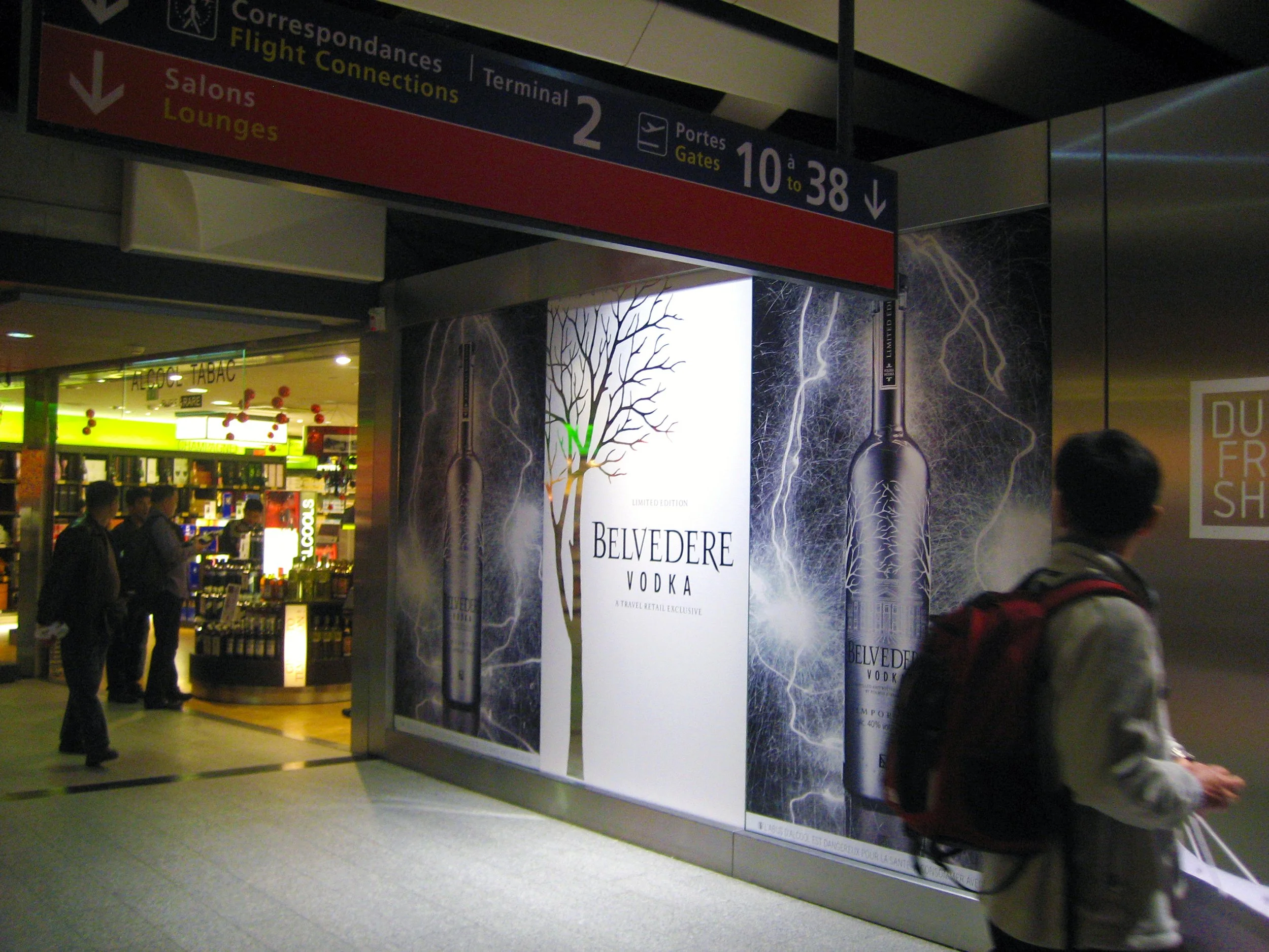 Belvedere bottle artwork and tree graphics installed beside a duty-free shop at Charles de Gaulle Airport.